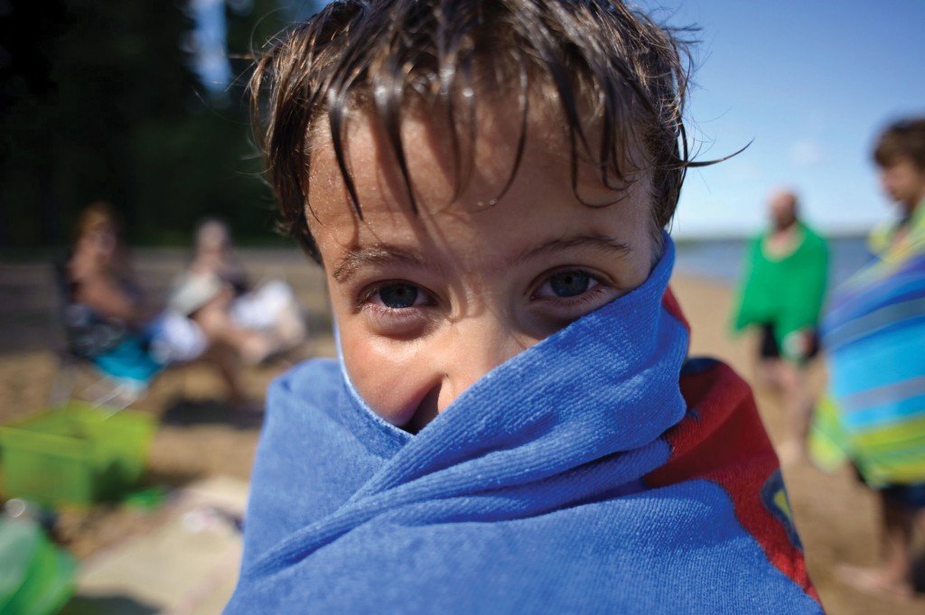 boy wrapped in towel after swim