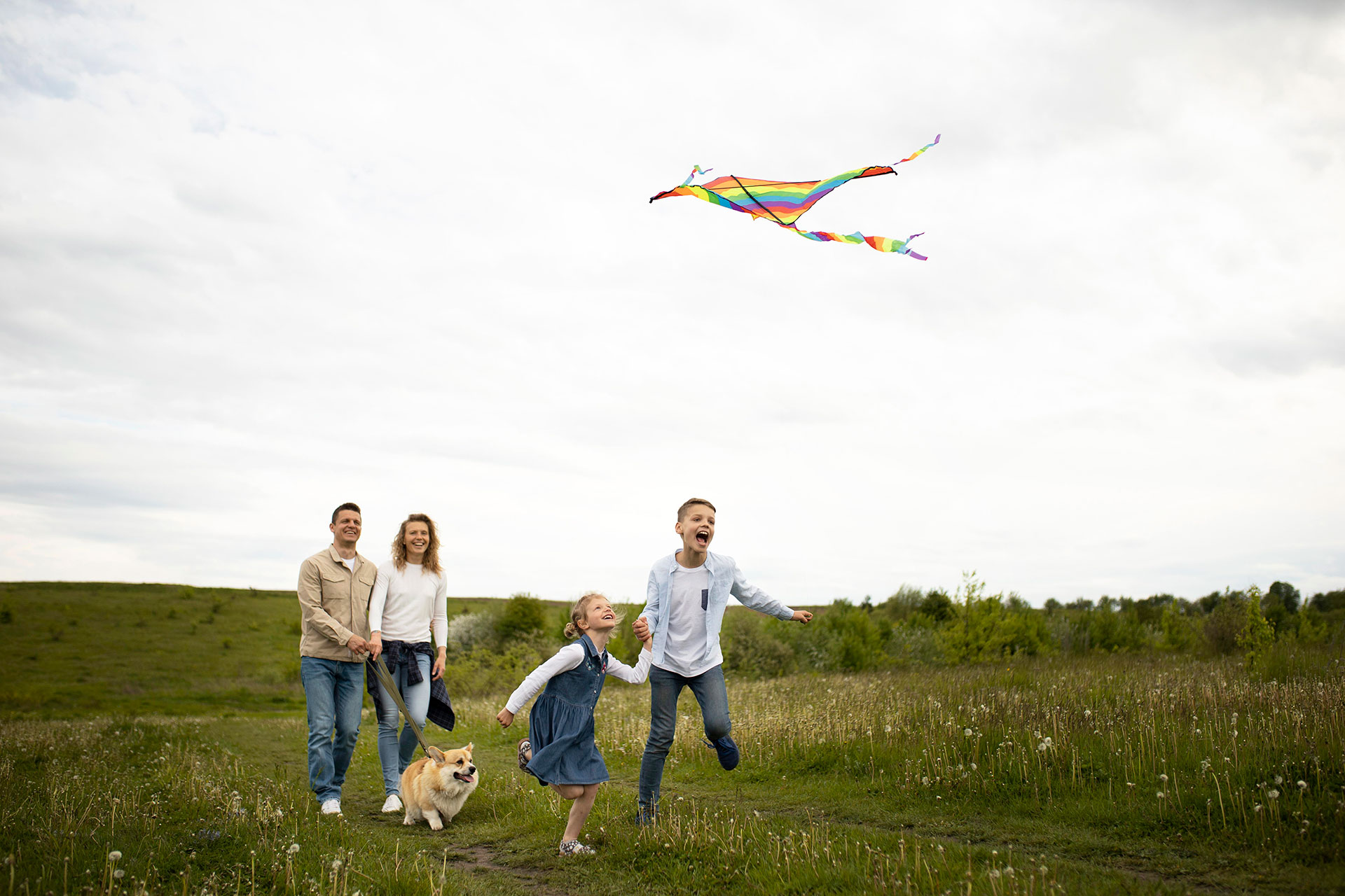 Happy family flying kite.